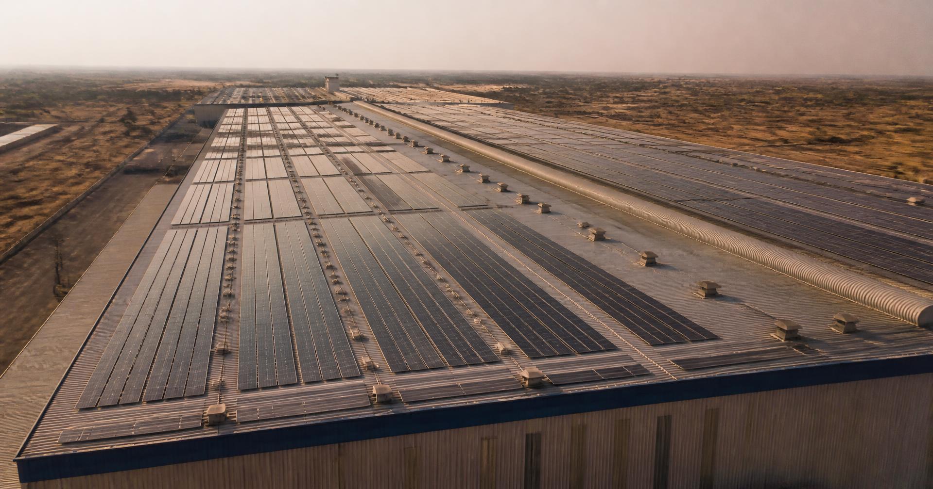 Solar panels covering a large industrial shed roof